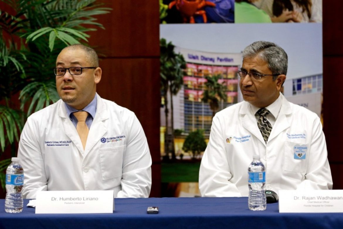 Humberto Liraino, left, makes comments during a news conference as Rajan Wadhawan listens at Florida Hospital